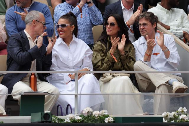 US actor Brad Pitt (R) sits with his partner US Ines de Ramon (2R), US musician Flea (L) and US fashion designer Melody Ehsani (2L) on Court Philippe-Chatrier ahead of the women's final singles match on day 14 of the French Open tennis tournament at the Roland-Garros Complex in Paris on June 6, 2026. (Photo by Thomas SAMSON / AFP)