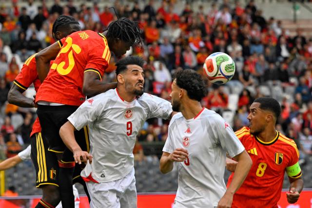 Belgium's defender #25 Nathan Ngoy (L) heads the ball next to Tunisia's forward #9 Hazem Mastouri (2ndL) during the international friendly football match between Belgium and Tunisia at the King Baudouin Stadium in Brussels on June 6, 2026. (Photo by JOHN THYS / AFP)