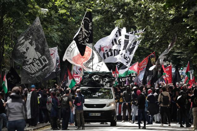 Demonstrators hold flags and banners  as they take part of a march to mark the 13th anniversary of the death in 2013 of anti-fascist militant Clement Meric, who died after a brawl with skinheads, in Paris on June 6, 2026. (Photo by STEPHANE DE SAKUTIN / AFP)