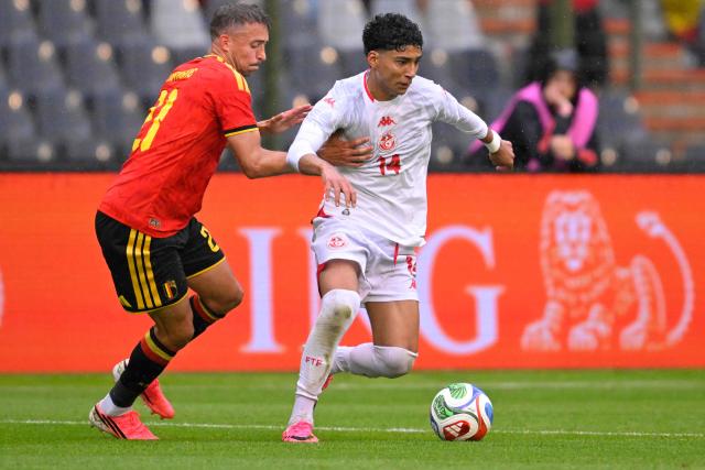 Belgium's defender #21 Timothy Castagne (L) fights for the ball with Tunisia's forward #14 Khalil Ayari during the international friendly football match between Belgium and Tunisia at the King Baudouin Stadium in Brussels on June 6, 2026. (Photo by JOHN THYS / AFP)