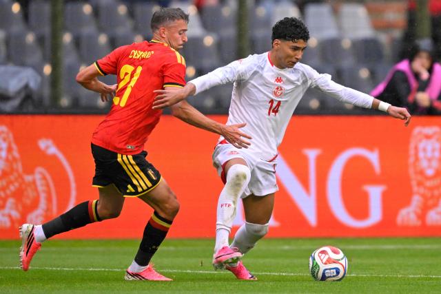 Belgium's defender #21 Timothy Castagne (L) fights for the ball with Tunisia's forward #14 Khalil Ayari during the international friendly football match between Belgium and Tunisia at the King Baudouin Stadium in Brussels on June 6, 2026. (Photo by JOHN THYS / AFP)