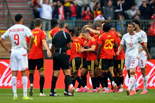 Belgium's forward #10 Leandro Trossard is congratulated by teammates after scoring the opening goal during the international friendly football match between Belgium and Tunisia at the King Baudouin Stadium in Brussels on June 6, 2026. (Photo by JOHN THYS / AFP)
