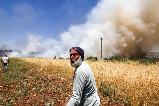 Men attempt to extinguish a fire in a field in the Palestinian town of Huwara in the occupied West Bank on June 6, 2026, after a reported arson attack by Israeli settlers according to local officials. Shielded by what Palestinians and rights group describe as complete impunity from the law, some Israeli settlers have harassed rural Palestinian communities, vandalising property, committing arson, sometimes killing. Excluding east Jerusalem, more than 500,000 Israelis live in the occupied West Bank in settlements that are illegal under international law, among some three million Palestinians. Israel has occupied the West Bank since 1967. (Photo by JAAFAR ASHTIYEH / AFP)