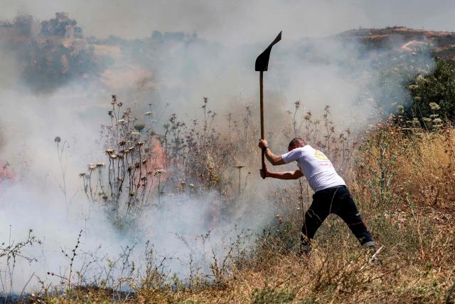 A man attempts to extinguish a fire in a field in the Palestinian town of Huwara in the occupied West Bank on June 6, 2026, after a reported arson attack by Israeli settlers according to local officials. Shielded by what Palestinians and rights group describe as complete impunity from the law, some Israeli settlers have harassed rural Palestinian communities, vandalising property, committing arson, sometimes killing. Excluding east Jerusalem, more than 500,000 Israelis live in the occupied West Bank in settlements that are illegal under international law, among some three million Palestinians. Israel has occupied the West Bank since 1967. (Photo by Jaafar ASHTIYEH / AFP)