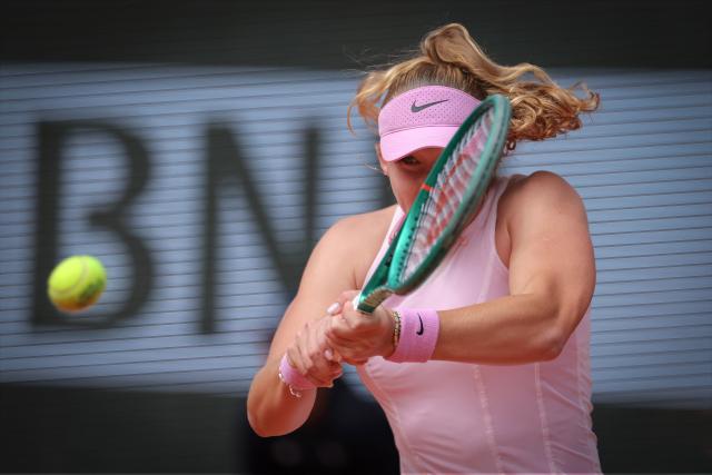 Russia's Mirra Andreeva plays a backhand return to Poland's Maja Chwalinska during their women's final singles match on day 14 of the French Open tennis tournament on Court Philippe-Chatrier at the Roland-Garros Complex in Paris on June 6, 2026. (Photo by Thomas SAMSON / AFP)