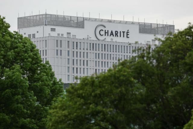 (FILES) The main building of the Charite hospital is pictured is seen behind trees in Berlin on May 11, 2026. The German hospital on June 6, 2026 said it has discharged a US man who caught Ebola in the Democratic Republic of Congo, after 17 days of antiviral treatment and medical care cured him of the often deadly infection. The Charite public hospital in Berlin said the man -- who had been working as a surgeon for a Christian missionary group in the DRC -- and his five family members who had all been in quarantine were in "good health" and permitted to leave. (Photo by Odd ANDERSEN / AFP)