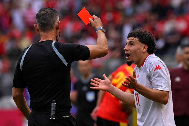 Tunisia's forward #11 Ismael Gharbi (R) is shown a red card by referee Anastasios Sidiropoulos during the international friendly football match between Belgium and Tunisia at the King Baudouin Stadium in Brussels on June 6, 2026. (Photo by JOHN THYS / AFP)