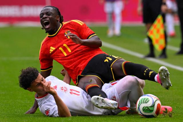 Belgium's forward #11 Jeremy Doku (up) is tackled by Tunisia's midfielder #11 Ismael Gharbi during the international friendly football match between Belgium and Tunisia at the King Baudouin Stadium in Brussels on June 6, 2026. (Photo by JOHN THYS / AFP)