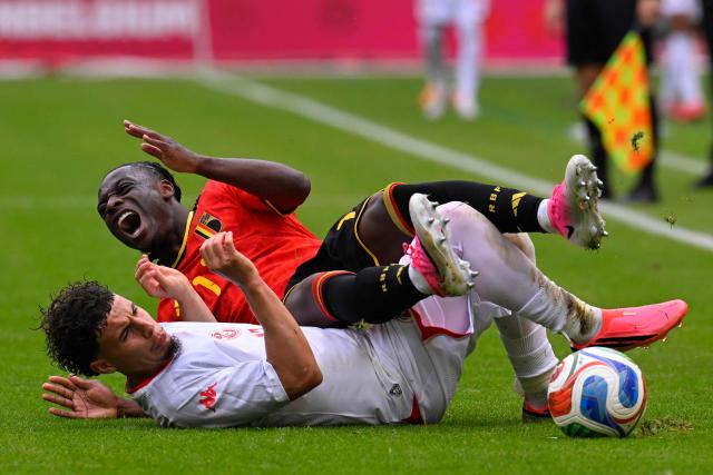 Belgium's forward #11 Jeremy Doku (up) is tackled by Tunisia's midfielder #11 Ismael Gharbi during the international friendly football match between Belgium and Tunisia at the King Baudouin Stadium in Brussels on June 6, 2026. (Photo by JOHN THYS / AFP)