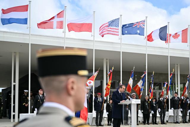 France's Prime Minister Sebastien Lecornu delivers a speech during an International commemorative ceremony for the 82nd anniversary of the World War II "D-Day" Normandy landings in Langrune-sur-Mer, northwestern France, of June 6, 2026. (Photo by LOU BENOIST / AFP)