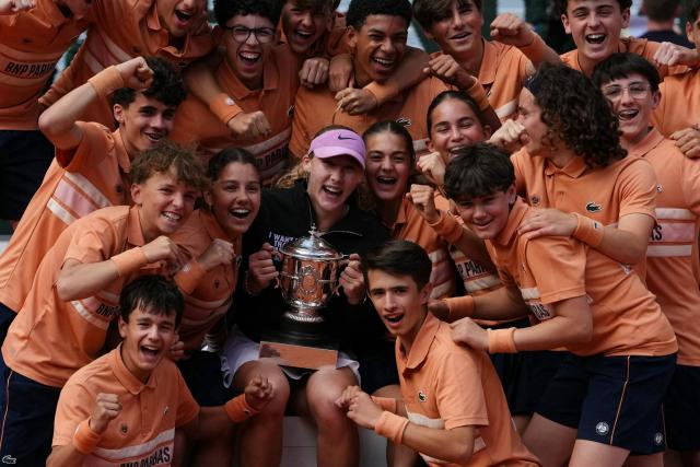 Russia's Mirra Andreeva poses with ball girls and ball boys after winning the French Open tennis tournament women's singles final match against Poland's Maja Chwalinska on day 14 of the French Open tennis tournament on Court Philippe-Chatrier at the Roland-Garros Complex in Paris on June 6, 2026. (Photo by Dimitar DILKOFF / AFP)