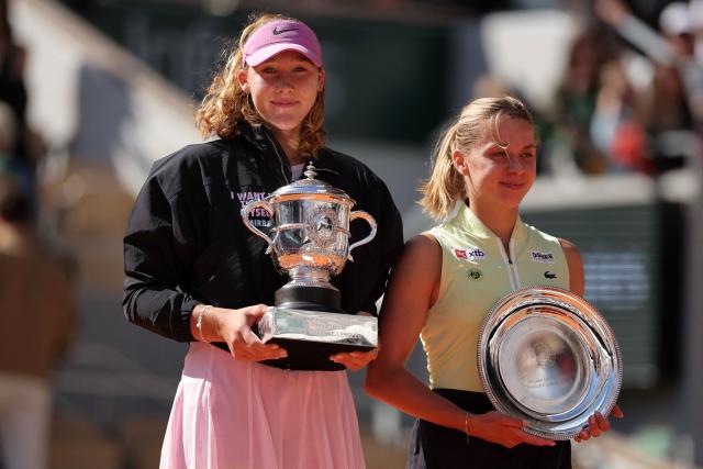 Russia's Mirra Andreeva, next to runner up Poland's Maja Chwalinska (R), poses with the trophy after winning the French Open tennis tournament women's singles final match against Poland's Maja Chwalinska on day 14 of the French Open tennis tournament on Court Philippe-Chatrier at the Roland-Garros Complex in Paris on June 6, 2026. (Photo by Thomas SAMSON / AFP)