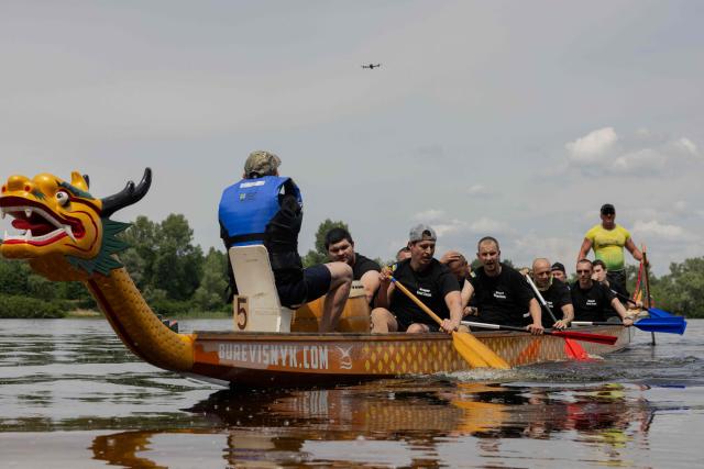 Ukrainian soldiers take part in a Dragon Boat Veterans racing competition in Kyiv on June 6, 2026, amid the Russian invasion of Ukraine. The Dragon Boat racing, which traces its origins to ancient China, is nowadays conducted  to help injured service members and military veterans regain physical fitness, mental wellbeing and a sense of community through sport. (Photo by Tetiana DZHAFAROVA / AFP)