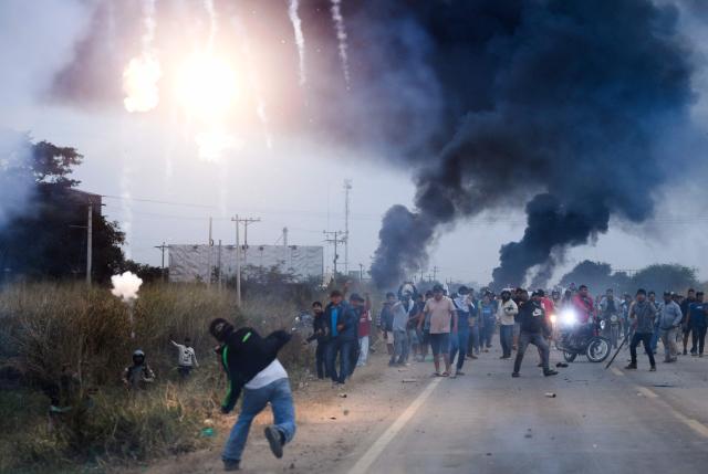 Anti-government demonstrators clash with police officers and civilians during an operation to clear a road blockade in San Julian, Santa Cruz department, Bolivia, on June 6, 2026. Bolivia has faced days of demonstrations and road blockades amid growing political tensions and shortages affecting different regions of the country. (Photo by Rodrigo URZAGASTI / AFP)