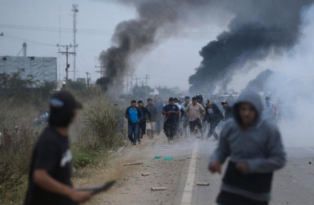 Anti-government demonstrators clash with police officers and civilians during an operation to clear a road blockade in San Julian, Santa Cruz department, Bolivia, on June 6, 2026. Bolivia has faced days of demonstrations and road blockades amid growing political tensions and shortages affecting different regions of the country. (Photo by Rodrigo URZAGASTI / AFP)