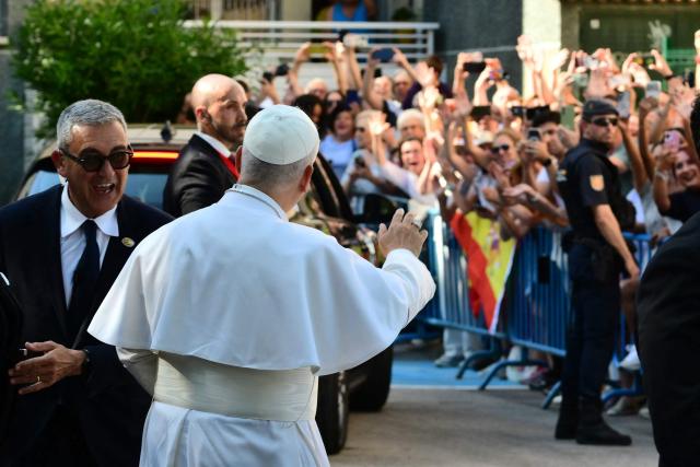 Pope Leo XIV waves to the faithful as he arrives to visit to Caritas charity's centre for homeless people “Cedia 24 horas” in Lucero neighbourhood in Madrid, on June 6, 2026. Pope Leo XIV is visiting Spain June 6-12 with stops in Madrid, Barcelona, and the Canary Islands, where he will meet with migrants and organisations dedicated to helping them. (Photo by Stefano RELLANDINI / AFP)