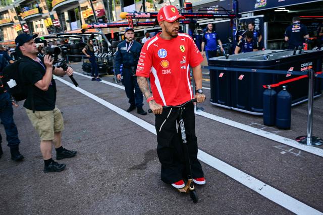 Ferrari's British driver Lewis Hamilton leaves the paddock on a scooter after competing in the qualifying session at the Monaco street circuit in Monaco, ahead of the Monaco Formula 1 Grand Prix, on June 6, 2026. (Photo by Andrej ISAKOVIC / AFP)