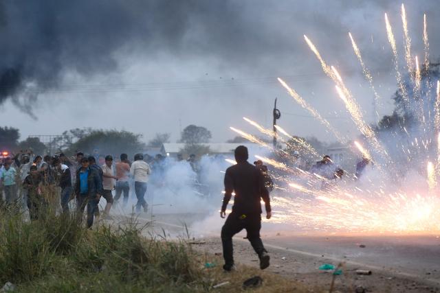 Anti-government demonstrators clash with police officers and civilians during an operation to clear a road blockade in San Julian, Santa Cruz department, Bolivia, on June 6, 2026. Bolivia has faced days of demonstrations and road blockades amid growing political tensions and shortages affecting different regions of the country. (Photo by Rodrigo URZAGASTI / AFP)