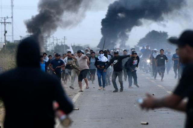 Anti-government demonstrators clash with police officers and civilians during an operation to clear a road blockade in San Julian, Santa Cruz department, Bolivia, on June 6, 2026. Bolivia has faced days of demonstrations and road blockades amid growing political tensions and shortages affecting different regions of the country. (Photo by Rodrigo URZAGASTI / AFP)
