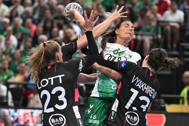 Brest Bretagne's German left back Annika Lott (L), Gyori's Danish centre back Helena Elver Hageso (C) and Brest Bretagne's Russian right back Anna Vyakhireva (R) vie for the ball during the EHF Women's Handball Champions League semi-final match between Brest Bretagne Handball and Gyori Audi ETO KC in Budapest on June 6, 2026. (Photo by Attila KISBENEDEK / AFP)