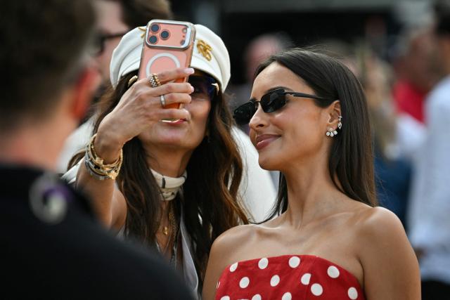 French influencer Alexandra Malena Leclerc and wife of Ferrari's Monegasque driver Charles Leclerc (R) poses for pictures in the paddock after attending the qualifying session at the Monaco street circuit in Monaco, ahead of the Monaco Formula 1 Grand Prix, on June 6, 2026. (Photo by Andrej ISAKOVIC / AFP)