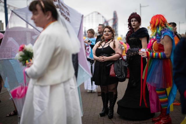People arrive to attend the Pride parade on the Promenade in Blackpool, north west England on June 6, 2026. (Photo by Oli SCARFF / AFP)