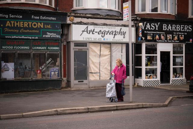 A woman waits at a bus stop in Blackpool, north west England on June 6, 2026. (Photo by Oli SCARFF / AFP)