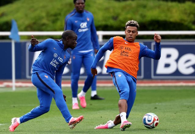 France's midfielder #13 Ngolo Kante (L) fights for the ball with France's forward #20 Desire Doue during a training session at the French Football Federation's (FFF) training ground in Clairefontaine-en-Yvelines, southwest of Paris on June 6, 2026, as part of the team's preparation for upcoming 2026 FIFA World Cup football tournament. (Photo by FRANCK FIFE / AFP)