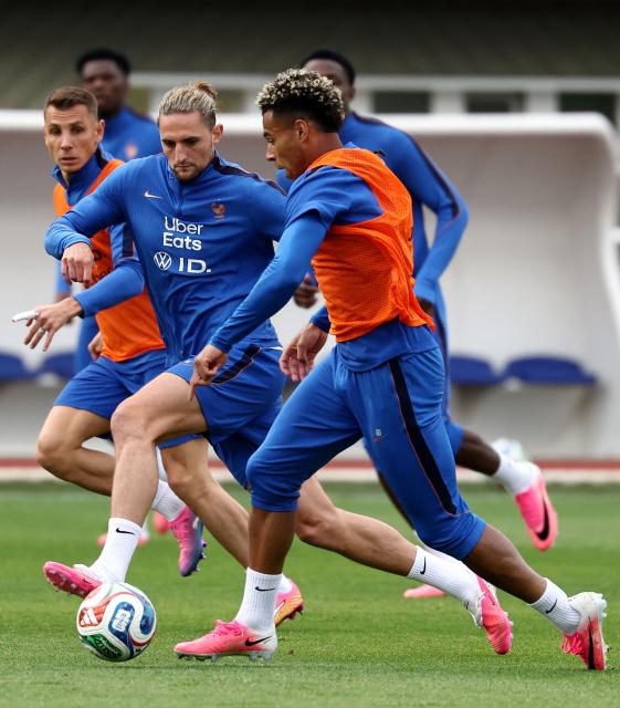France's midfielder #14 Adrien Rabiot (C) fights for the ball with France's forward #20 Desire Doue during a training session at the French Football Federation's (FFF) training ground in Clairefontaine-en-Yvelines, southwest of Paris on June 6, 2026, as part of the team's preparation for upcoming 2026 FIFA World Cup football tournament. (Photo by FRANCK FIFE / AFP)