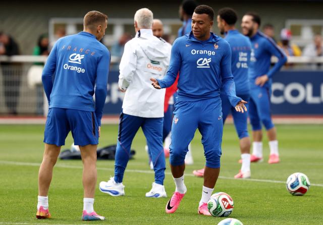 France's forward #10 Kylian Mbappe (R) speaks with France's defender #03 Lucas Digne (L) during a training session at the French Football Federation's (FFF) training ground in Clairefontaine-en-Yvelines, southwest of Paris on June 6, 2026, as part of the team's preparation for upcoming 2026 FIFA World Cup football tournament. (Photo by FRANCK FIFE / AFP)