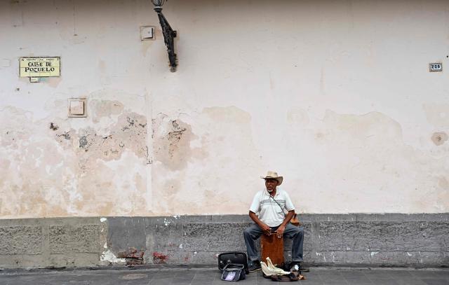 A man plays a traditional Peruvian Creole music 'cajon' on a street in downtown Lima on June 6, 2026 ahead of the presidential runoff. Right-wing candidate Keiko Fujimori and leftist Roberto Sanchez will face off in Peru's presidential runoff on June 7, 2026. (Photo by MARTIN BERNETTI / AFP)