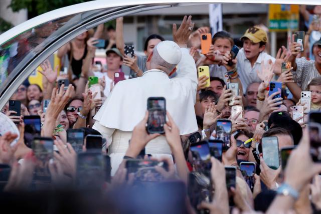 Pope Leo XIV waves to people on his way to lead a prayer vigil with young people in the Plaza de Lima in Madrid on June 6, 2026. Pope Leo XIV is visiting Spain June 6-12 with stops in Madrid, Barcelona, and the Canary Islands, where he will meet with migrants and organisations dedicated to helping them. (Photo by Oscar DEL POZO / AFP)