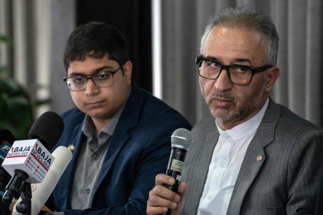 Iran's ambassador to Mexico Abolfazl Pasandideh (R) gestures during a press conference ahead of the arrival of the national football team for the FIFA 2026 World Cup football tournament, in Tijuana, Baja California, Mexico on June 6, 2026, Iran lashed out at the United States for refusing visas to some of its squad support staff as the players were to leave Turkey for Mexico, just days before the June 11 start of the 2026 World Cup, which is being jointly hosted by the United States, Mexico and Canada. (Photo by Chris Noyola / AFP)