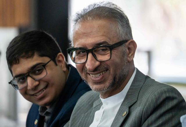 Iran's ambassador to Mexico Abolfazl Pasandideh (R) smiles during a press conference ahead of the arrival of the national football team for the FIFA 2026 World Cup football tournament, in Tijuana, Baja California, Mexico on June 6, 2026, Iran lashed out at the United States for refusing visas to some of its squad support staff as the players were to leave Turkey for Mexico, just days before the June 11 start of the 2026 World Cup, which is being jointly hosted by the United States, Mexico and Canada. (Photo by Chris Noyola / AFP)