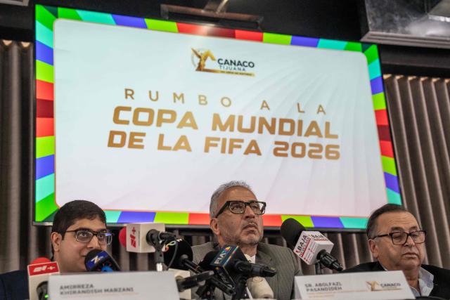 Iran's ambassador to Mexico Abolfazl Pasandideh (C) gestures during a press conference ahead of the arrival of the national football team for the FIFA 2026 World Cup football tournament, in Tijuana, Baja California, Mexico on June 6, 2026, Iran lashed out at the United States for refusing visas to some of its squad support staff as the players were to leave Turkey for Mexico, just days before the June 11 start of the 2026 World Cup, which is being jointly hosted by the United States, Mexico and Canada. (Photo by Chris Noyola / AFP)