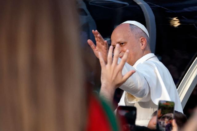 Pope Leo XIV waves to people on his way to lead a prayer vigil with young people in the Plaza de Lima in Madrid on June 6, 2026. Pope Leo XIV is visiting Spain June 6-12 with stops in Madrid, Barcelona, and the Canary Islands, where he will meet with migrants and organisations dedicated to helping them. (Photo by Oscar DEL POZO / AFP)