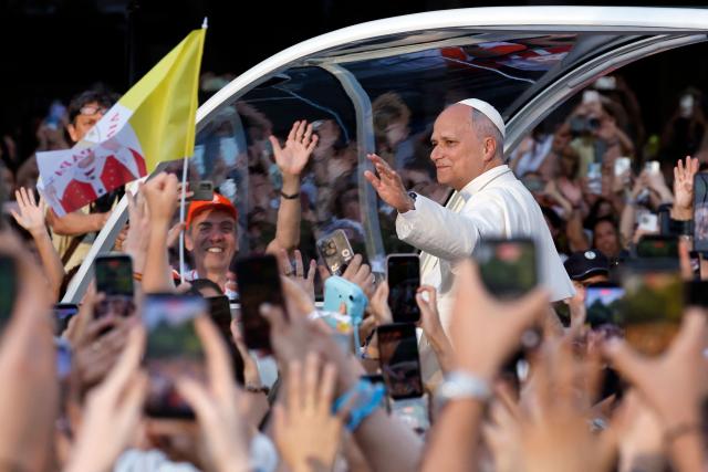 Pope Leo XIV waves to people on his way to lead a prayer vigil with young people in the Plaza de Lima in Madrid on June 6, 2026. Pope Leo XIV is visiting Spain June 6-12 with stops in Madrid, Barcelona, and the Canary Islands, where he will meet with migrants and organisations dedicated to helping them. (Photo by Oscar DEL POZO / AFP)