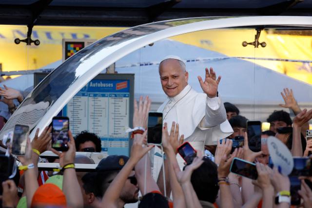 Pope Leo XIV waves to people on his way to lead a prayer vigil with young people in the Plaza de Lima in Madrid on June 6, 2026. Pope Leo XIV is visiting Spain June 6-12 with stops in Madrid, Barcelona, and the Canary Islands, where he will meet with migrants and organisations dedicated to helping them. (Photo by Oscar DEL POZO / AFP)