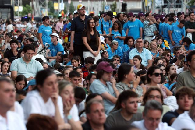 Young people attend a prayer vigil led by Pope Leo XIV in the Plaza de Lima in Madrid, with the Santiago Bernabeu stadium in the background, on June 6, 2026. Pope Leo XIV is visiting Spain June 6-12 with stops in Madrid, Barcelona, and the Canary Islands, where he will meet with migrants and organisations dedicated to helping them. (Photo by Pierre-Philippe MARCOU / AFP)