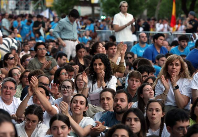 Young people attend a prayer vigil led by Pope Leo XIV in the Plaza de Lima in Madrid, with the Santiago Bernabeu stadium in the background, on June 6, 2026. Pope Leo XIV is visiting Spain June 6-12 with stops in Madrid, Barcelona, and the Canary Islands, where he will meet with migrants and organisations dedicated to helping them. (Photo by Pierre-Philippe MARCOU / AFP)