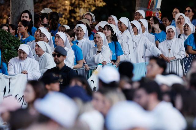 A group of nuns attend a prayer vigil led by Pope Leo XIV in the Plaza de Lima in Madrid, with the Santiago Bernabeu stadium in the background, on June 6, 2026. Pope Leo XIV is visiting Spain June 6-12 with stops in Madrid, Barcelona, and the Canary Islands, where he will meet with migrants and organisations dedicated to helping them. (Photo by Oscar DEL POZO / AFP)