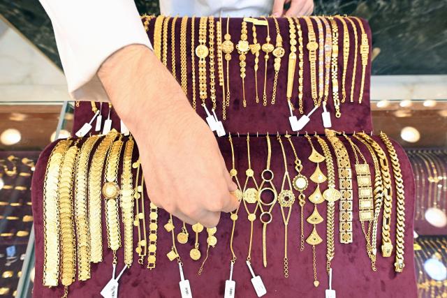 A Kuwaiti jeweller arranges gold items at a shop in downtown Kuwait City on June 6, 2026. (Photo by YASSER AL-ZAYYAT / AFP)