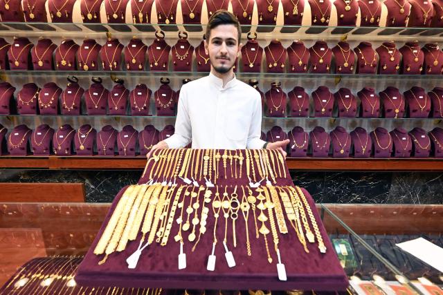A Kuwaiti jeweller displays gold items at a shop in downtown Kuwait City on June 6, 2026. (Photo by YASSER AL-ZAYYAT / AFP)