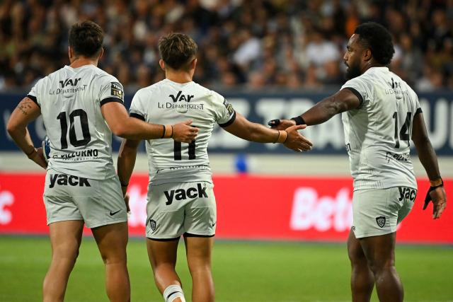 Toulon's Fijian centre Setariki Tuicuvu (R) celebrates with his teammates after scoring the team's first try during the French Top 14 rugby union match between Castres Olympique and Rugby Club Toulonnais (Toulon)  at Stade Pierre Fabre in Castres, southern France on June 6, 2026. (Photo by Matthieu RONDEL / AFP)