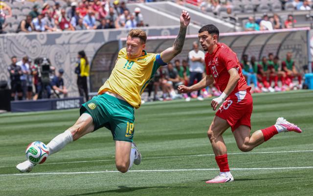 Australia's Ajdin Hrustic (L) and Switzerland's Zeki Amdouni battle for the ball during a friendly match at Snapdragon Stadium in San Diego, California, on June 6, 2026, ahead of the 2026 FIFA World Cup. (Photo by SANDY HUFFAKER / AFP)