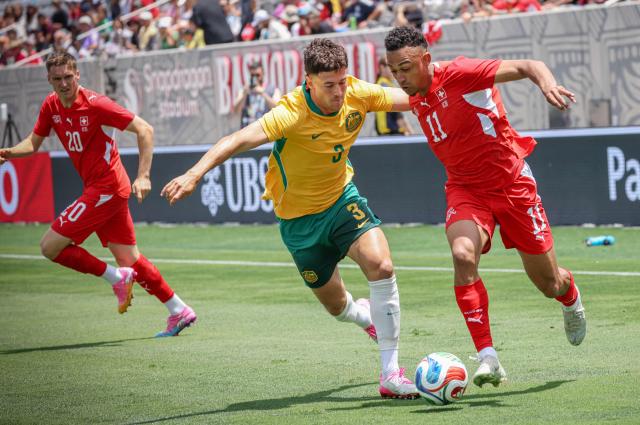 Australia's Silvan Widmer and Switzerland''s Dan Ndoye battle for the ball during a friendly match at Snapdragon Stadium in San Diego, California, on  June 6, 2026, ahead of the 2026 FIFA World Cup. (Photo by SANDY HUFFAKER / AFP)