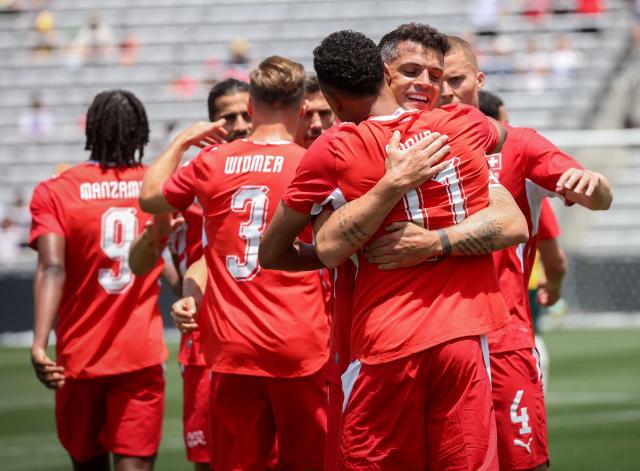 Switzerland's Nico Elvedi (R) congratulates teammate Dan Ndoye after he scored in the first half against Australia during a friendly match at Snapdragon Stadium in San Diego, California, on June 6, 2026, ahead of the 2026 FIFA World Cup. (Photo by SANDY HUFFAKER / AFP)