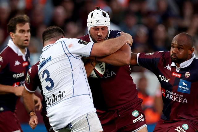 Bordeaux' Tongan lock Adam Coleman (C) is tackled by Clermont's French prop Regis Montagne during the French Top14 rugby union match between Union Bordeaux-Begles (UBB) and ASM Clermont Auvergne at the Chaban-Delmas Stadium in Bordeaux, south-western France on June 6, 2026. (Photo by ROMAIN PERROCHEAU / AFP)