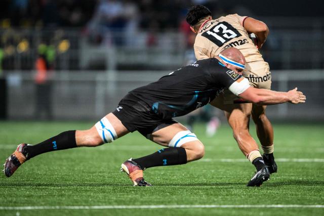 Lyon's New-Zealand centre Josiah Maraku (R) is tackled by Montpellier’s Canadian lock Tyler Duguid during the French Top14 rugby union match between Lyon Olympique Universitaire Rugby and  Montpellier Herault Rugby at the Gerland Stadium in Lyon, central-eastern France on June 6, 2026. (Photo by OLIVIER CHASSIGNOLE / AFP)