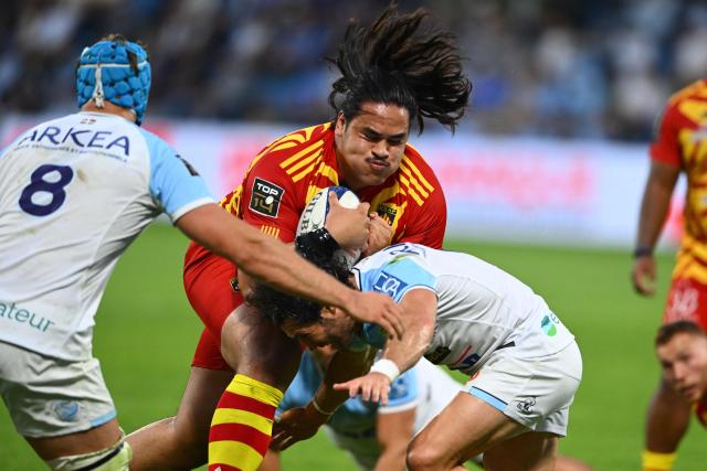 Perpignan's French lock Posolo Tuilagi (C) is tackled as he runs with the ball during the French Top14 rugby union match between Aviron Bayonnais (Bayonne) and USA Perpignan at Stade Jean Dauger in Bayonne, south-western France on June 6, 2026. (Photo by Gaizka IROZ / AFP)